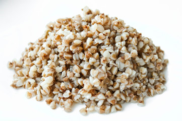 Buckwheat. Boiled buckwheat grains on a white plate. Concept food background.