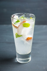 Sweet coconut mojito cocktail on the wooden background. Selective focus. Shallow depth of field.