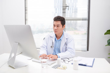 Portrait of senior doctor sitting in medical office