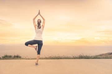 Peaceful calm meditation at sunset. Female meditating.