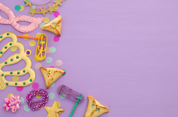 Obraz na płótnie Canvas Purim celebration concept (jewish carnival holiday) over wooden pink background
