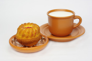 Cookies on a saucer and a cup of milk on a white background.Isolated on white.