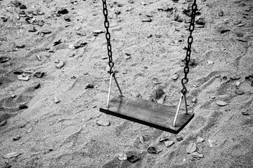 Empty swing set in the park - monochrome