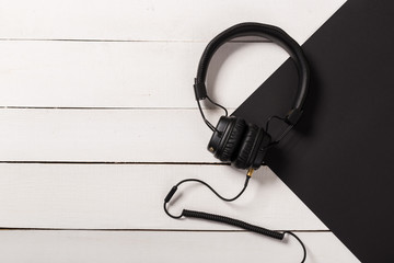 Headphones on white wooden background