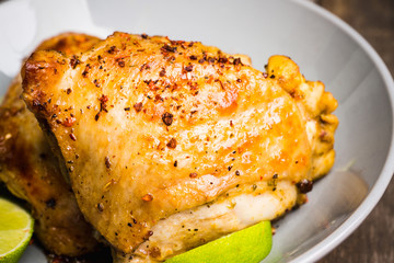 Spicy roasted chicken with lime. Selective focus. Shallow depth of field.