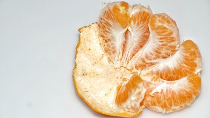 Ripe juicy peeled mandarin orange. isolated on white background. Selected focus. Close up.