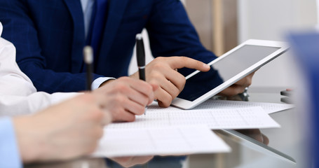 Obraz na płótnie Canvas Businessman using laptop at meeting, closeup of hands. Business operations concept
