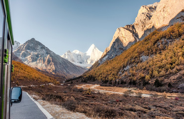 Yangmaiyong holy mountain in autumn valley on peak at Yading nature reserve
