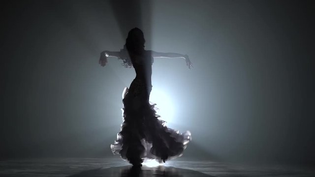 Woman belly dancer arabian in exotic white dress. Smoke background