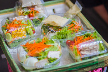 Close up vegetable salad vendor, selling on the sky walkway footpath nearby Chongnonsee BTS station, Bangkok, Thailand.