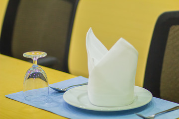 Glasses and plates on table setting for meeting and celebration