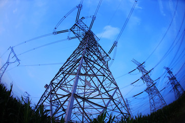 In the evening, the silhouette of high voltage towers