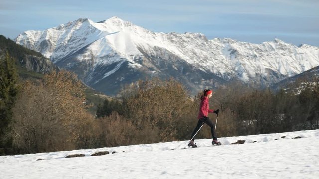 Woman Hikes In Front Of Stunning Mountain Backdrop, French Alps.