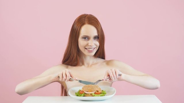 Happy redheaded anorexic girl is about to break the diet. Dependence. Diet.