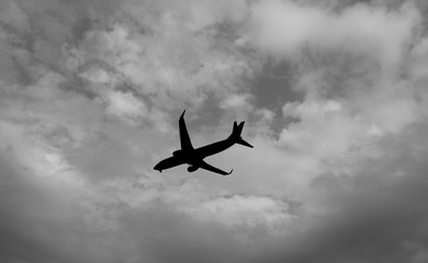 Scenery of airplane flying  through rainy dark sky to destination. 