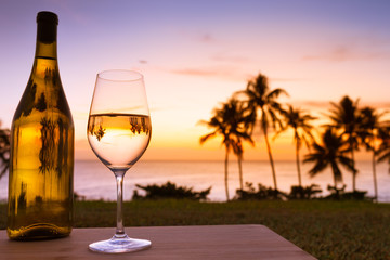 glass of white wine on the beach
