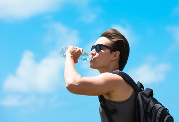 young man drinking from bottle of water
