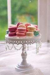 Full-length  of white plate with  marshmallow, macarons against the window. Elegant and luxurious.