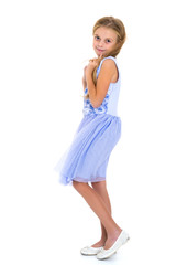 Little girl in a dress developing in the wind.