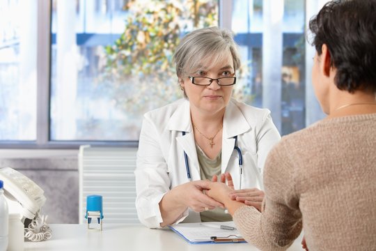 Mature female doctor talking to patient