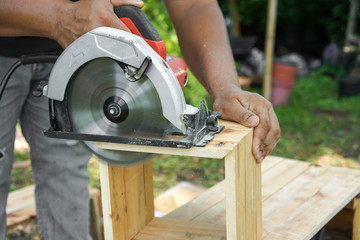 Asian carpenter are sawing the wood.