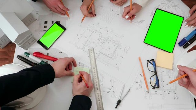 Shown close up on the drawing of building drawing pencils and drawbacks. As well as make notes with a pencil on the sticker