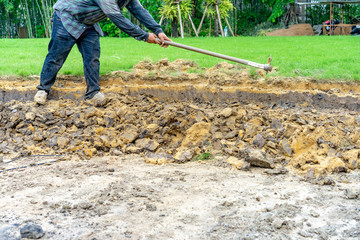 gardener digs the soil with his equipment for gardening and prepare land for plantation.