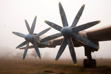  propellers of an old passenger plane in a hazy haze with blue frayed blades