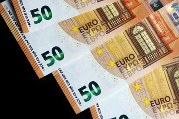 Fifty euro banknotes on a dark background close up