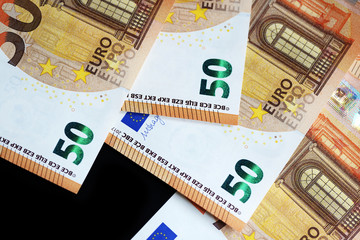 Fifty euro banknotes on a dark background close up