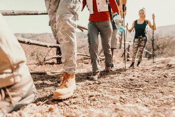 Close up of hikers' feet climbing. Hiking in nature at autumn concept.