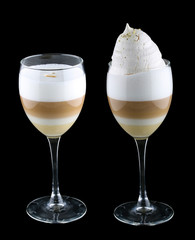 Coffee latte with meringue in glass on dark background