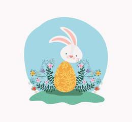 cute rabbit with egg painted and flowers in the garden