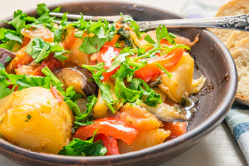 Roast vegetables on a rustic plate closeup - a healthy organic dish