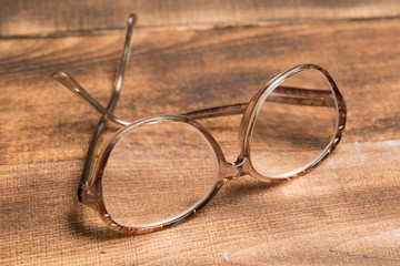 old glasses on wooden surface