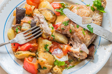 Delicious homemade chicken stew with vegetables on a plate, top view - organic healthy dish.