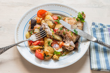 Delicious homemade chicken stew with vegetables on a plate, top view - organic healthy dish.