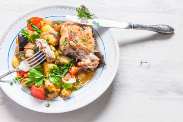 Tasty homemade chicken stew with vegetables on a plate, top view, copy space for a recipe - an organic healthy dish.