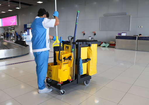 Closeup of woman cleaning worker doing her work with janitorial, cleaning equipment and tools.