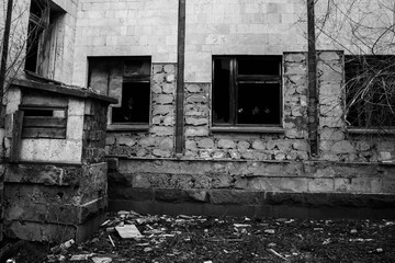 Those people in a dark black window of an abandoned building