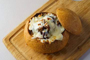 korean beef stew with cheese in bread bowl close up