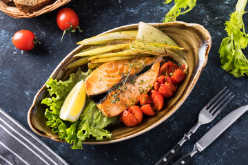 Grilled salmon fillets with baked vegetables. Top view