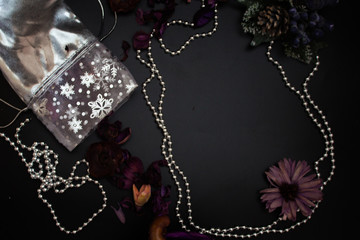 Silver chain around frame , purple flowers, silver envelope on a black background