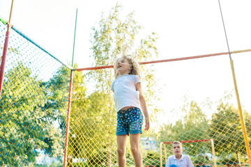 Happy funny girl jumping on trampoline