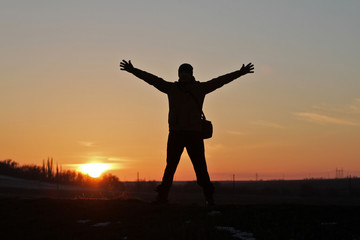 Fototapeta premium A man on the background of an incredible beautiful sunset.