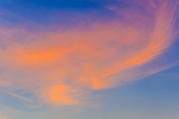 Naklejka na ściany i meble Red clouds on blue sky in twilight evening. Beautiful sunset sky with blue and red background. Dramatic colorful of dusk and dawn sky with blue sky and red clouds.