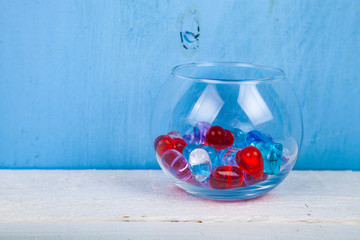 Multicolored glass hearts in a round vase
