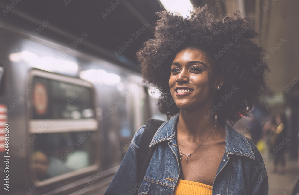 Wall mural young beautiful girl walking in time square metro station,getting the train. lifestyle concepts abou