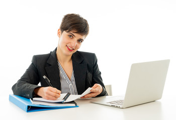 Portrait of happy attractive young businesswoman working on her laptop looking confident