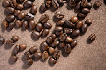 Roasted coffee beans on brown leather background